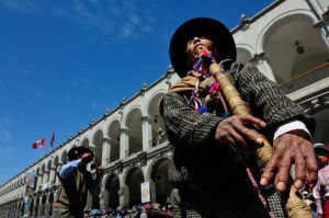 Playing a traditional Andean flute during the Arequipa anniversary celebrations